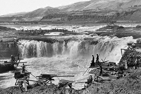 The railroad bridge in the background of this iconic view is the key to locating the falls today