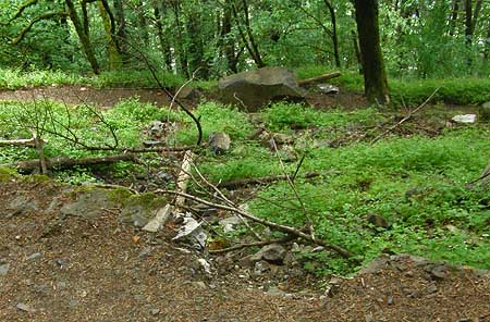 Looking down at the new boulder, the view is a bit more menacing, with a big bite taken out of the solid rock wall in the foreground, and a trail of debris, below.