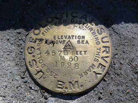 The original USGS survey marker at the east end of the bridge has been uncovered from years of debris