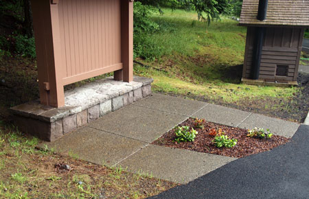 This refurbished sign kiosk has an unfortunate glitch: an ill-placed patch of landscaping