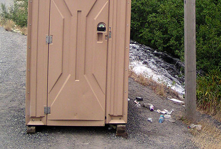 Camp Creek takes the brunt of trash and pollution from US 26. This scene is the unimproved roadside trailhead at Mirror Lake, where a chemical toilet (and associated trash) sits precariously above a steep bank dropping directly into the stream