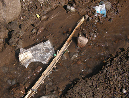 Ski areas don’t just bring invisible pollution to the Salmon River -- here, a broken boundary pole and ski trash litter the Salmon River headwaters.